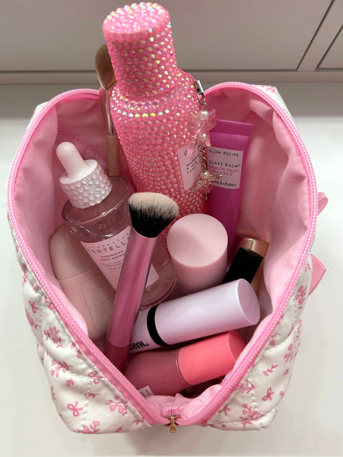 PrettyLittlePink bow makeup bag size reference with items inside